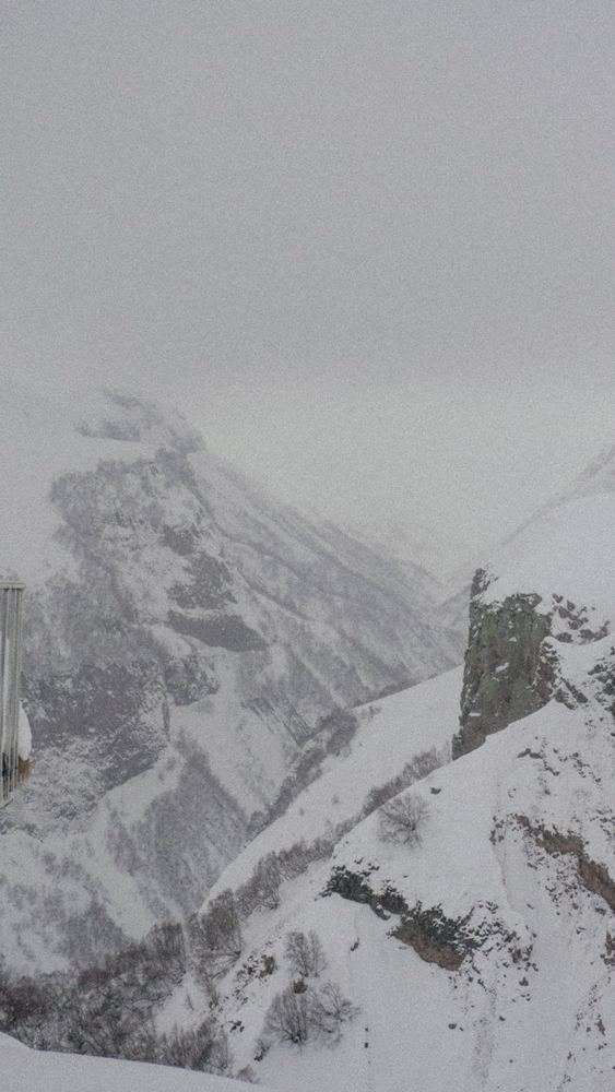 A film photograph of snow on a mountain ridge