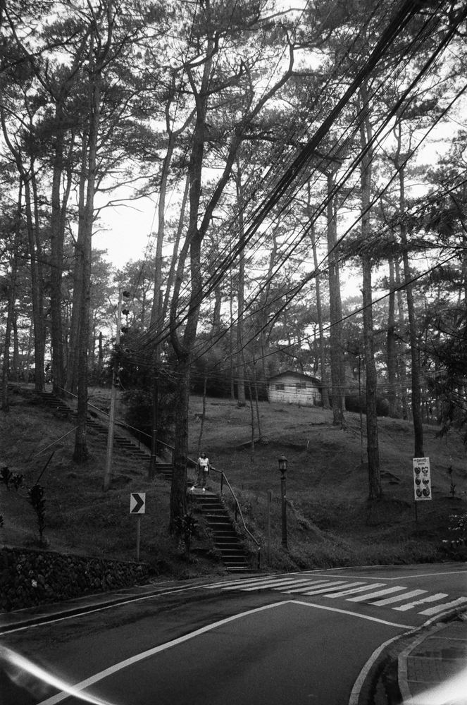A black and white photograph of a road