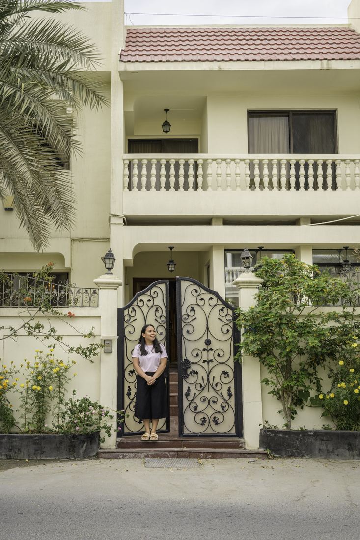 Documentary portrait of a person at the doorway of a house