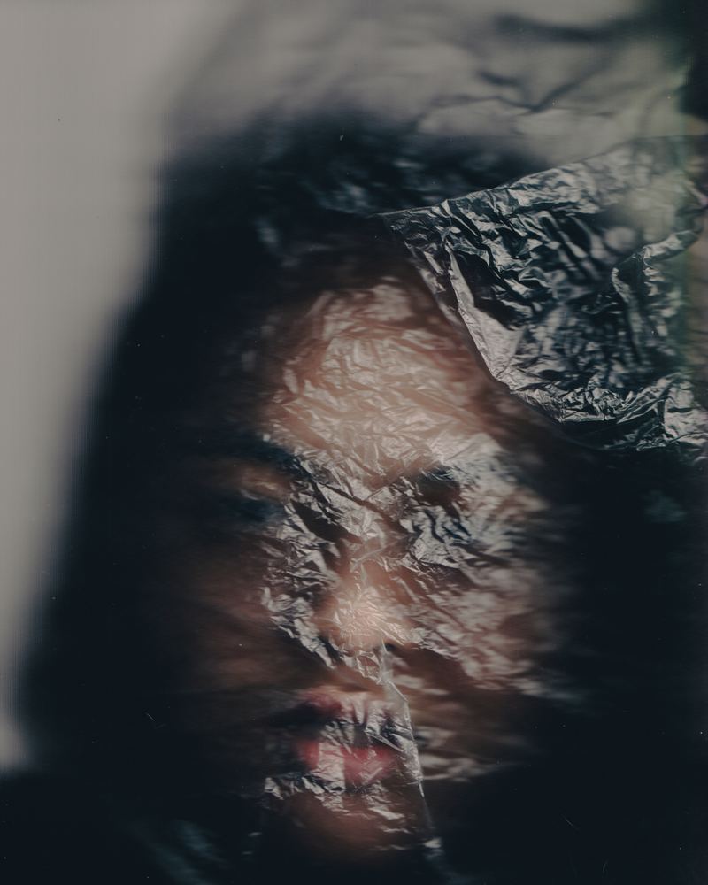 A scanned film frame of a face near water