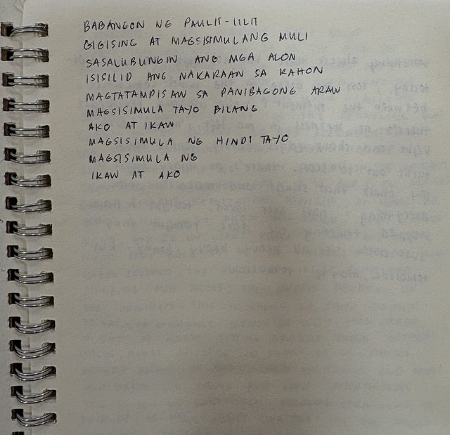 A handwritten page in a spiral notebook